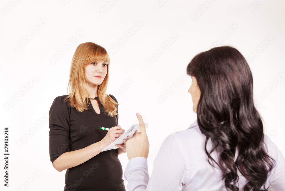 business woman giving instructions to her secretary in the offic business woman giving instructions to her secretary in the offic