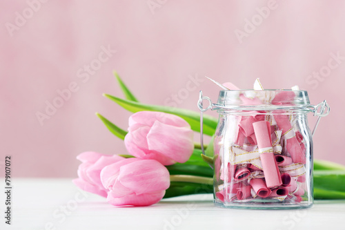 Fototapeta Naklejka Na Ścianę i Meble -  Beautiful pink tulips with jar of papers