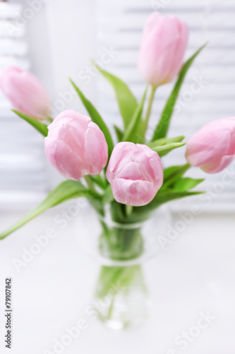 Fototapeta Naklejka Na Ścianę i Meble -  Beautiful pink tulips in glass vase on windowsill background