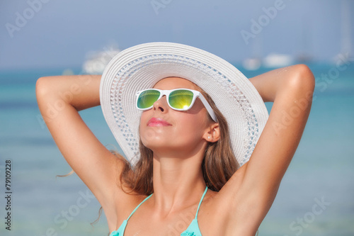 relaxed woman in sunshine on beach photo