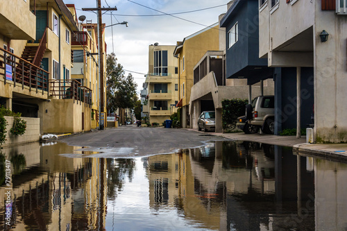 Buildings reflecting in a puddle in an alley, in Venice Beach, L