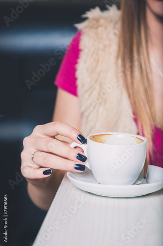Girl hand holding coffee cup