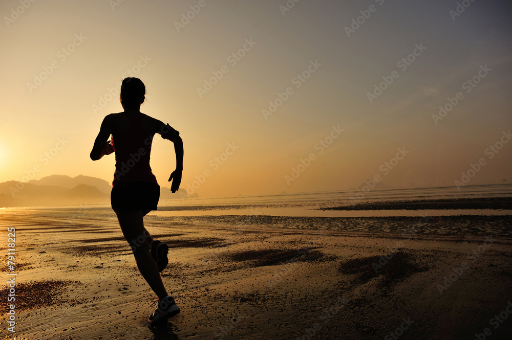 young woman running on sunrise beach 