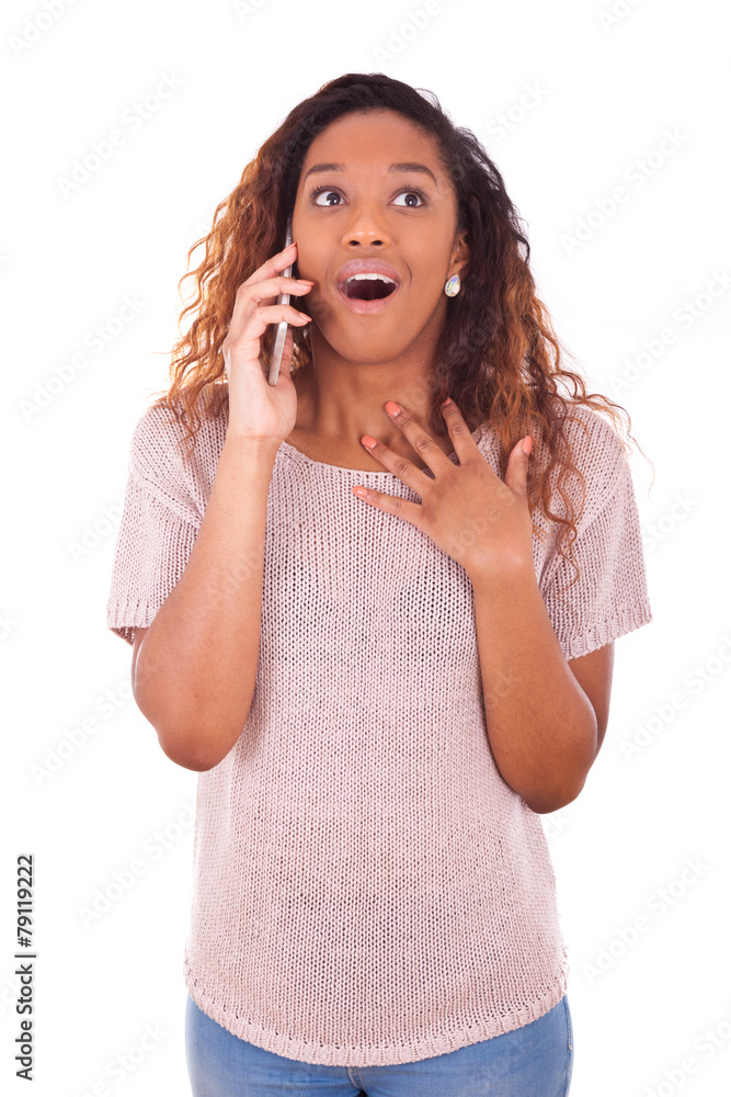 Ecstatic young African American woman making a phone call on her Ecstatic young African American woman making a phone call on her