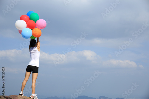 young asian woman mountain peak  with colored balloons  © lzf