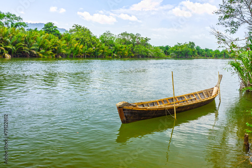 The traditional Thai wooden boat in natural Takua Pa river