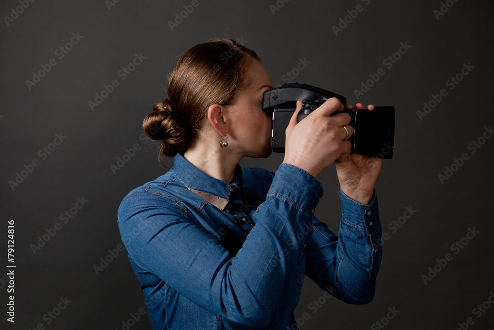 Photographer woman holding camera and taking pictures Photographer woman holding camera and taking pictures