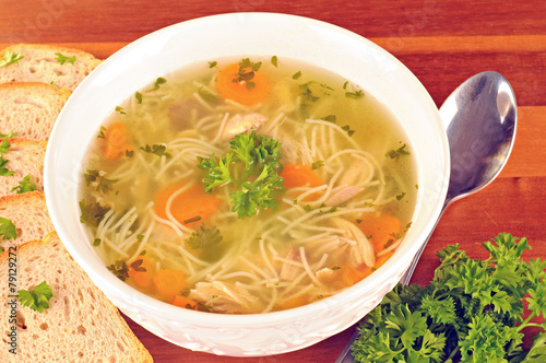 Bowl with chicken soup with vegetables and chicken meat