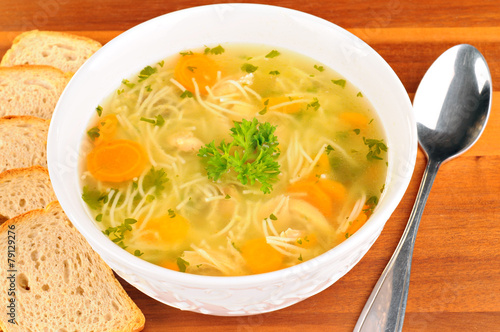 Bowl with chicken soup with vegetables and chicken meat