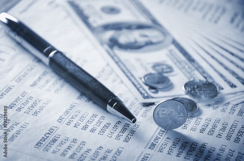 Closeup of money, pen and coins