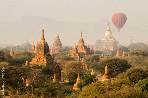 air balloons over Buddhist temples at sunrise. Bagan, Myanmar.