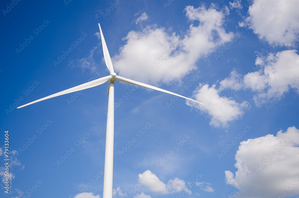 wind turbine against cloudy blue sky background wind turbine against cloudy blue sky background