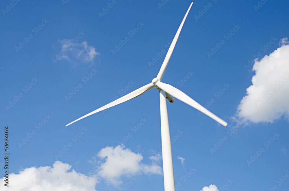 wind turbine against cloudy blue sky background wind turbine against cloudy blue sky background