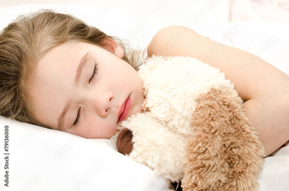 Adorable little girl sleeping with toy
