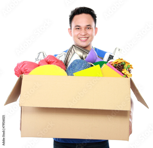 young man carrying box full of stuff