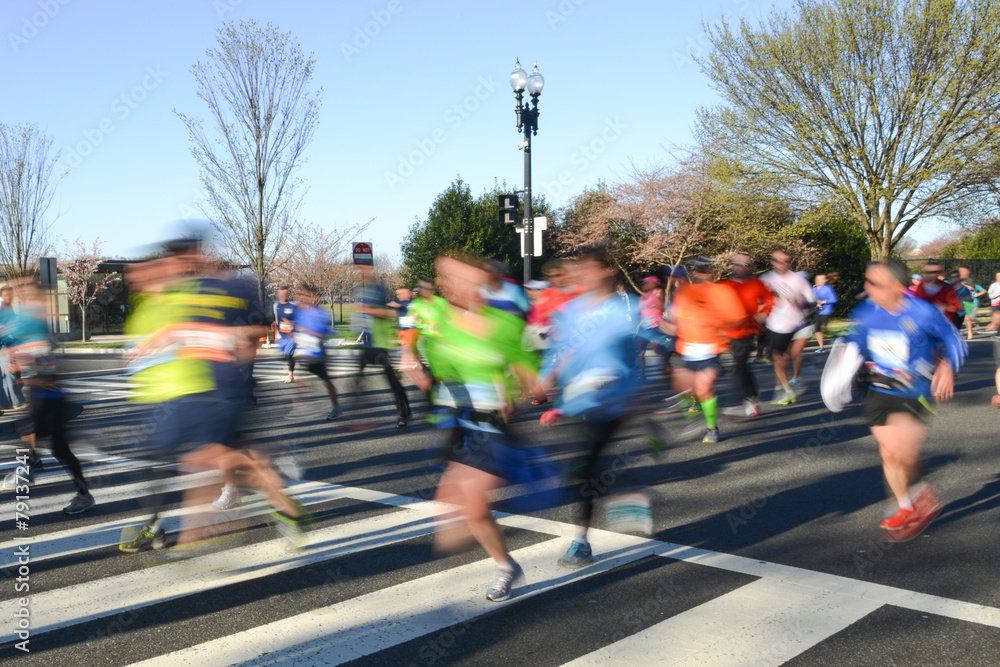 City marathon with runners in motion blur City marathon with runners in motion blur