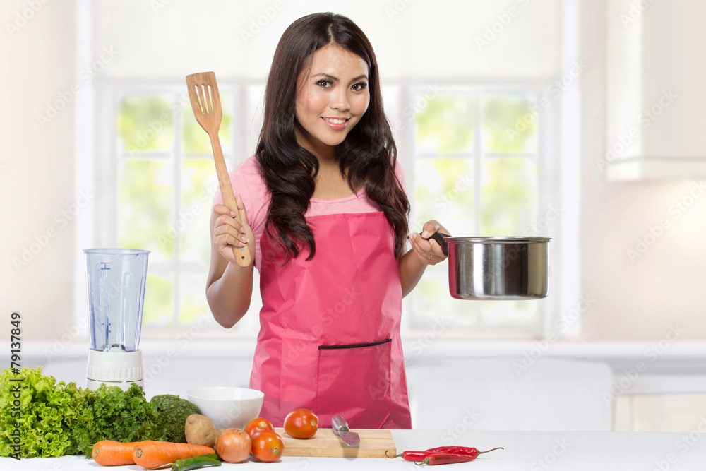 Young Woman Cooking in the kitchen