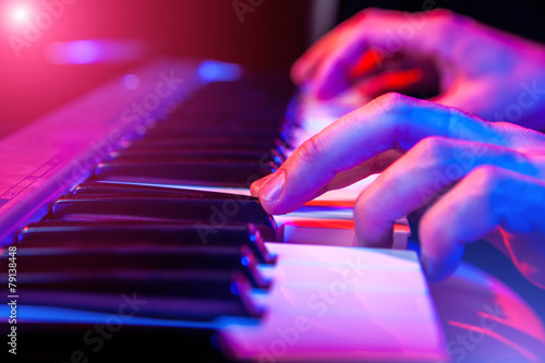hands of musician playing keyboard