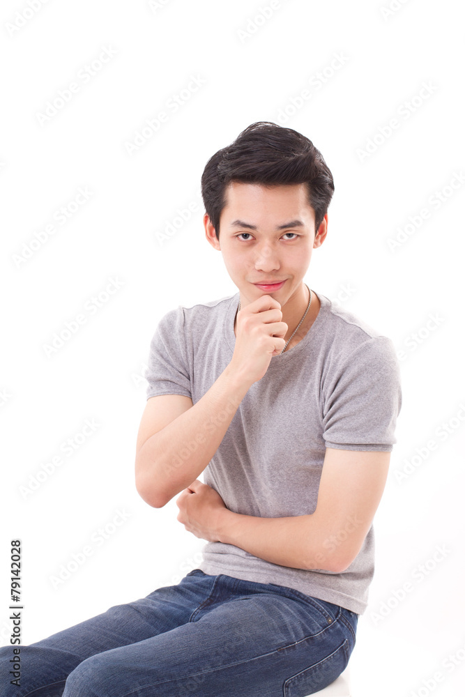 confident young man sitting with hand holding chin, white isolat confident young man sitting with hand holding chin, white isolat
