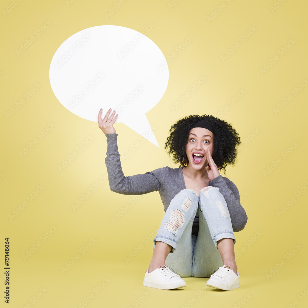 Happy girl holding a speech balloon with copy space. Happy girl holding a speech balloon with copy space.
