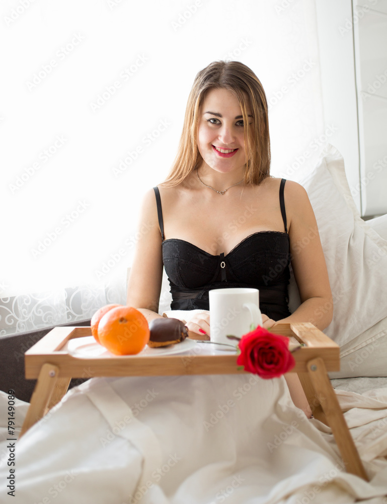 woman in lingerie having breakfast at hotel room