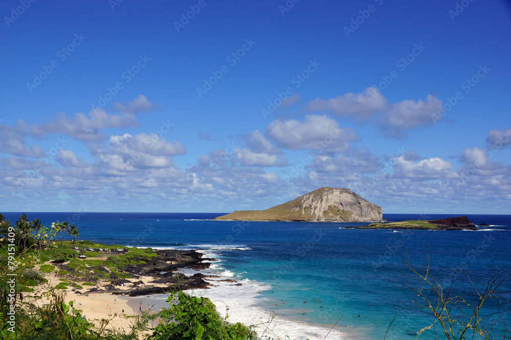 Makapuu beach with people in the water, and Rabbit and Rock Isla