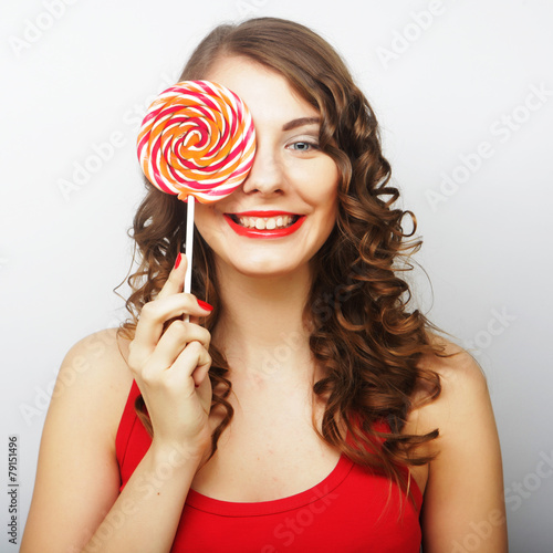 Young sexual woman holding lollipop.