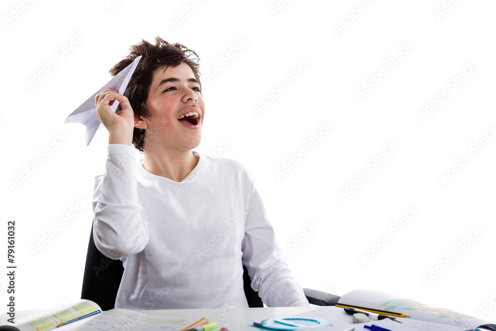 Latin boy playing with a paper airplane sitting in front of home Latin boy playing with a paper airplane sitting in front of home