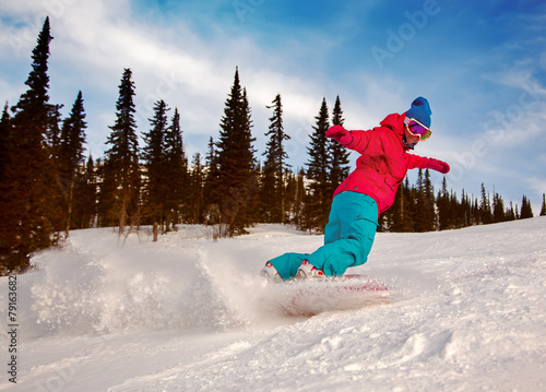 Snowboarder sliding down the hill