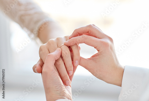 close up of lesbian couple hands with wedding ring