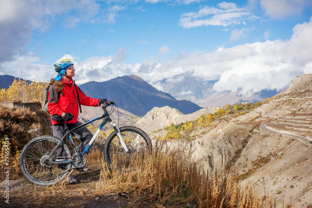 Biker-girl in Himalaya mountains, Anapurna region