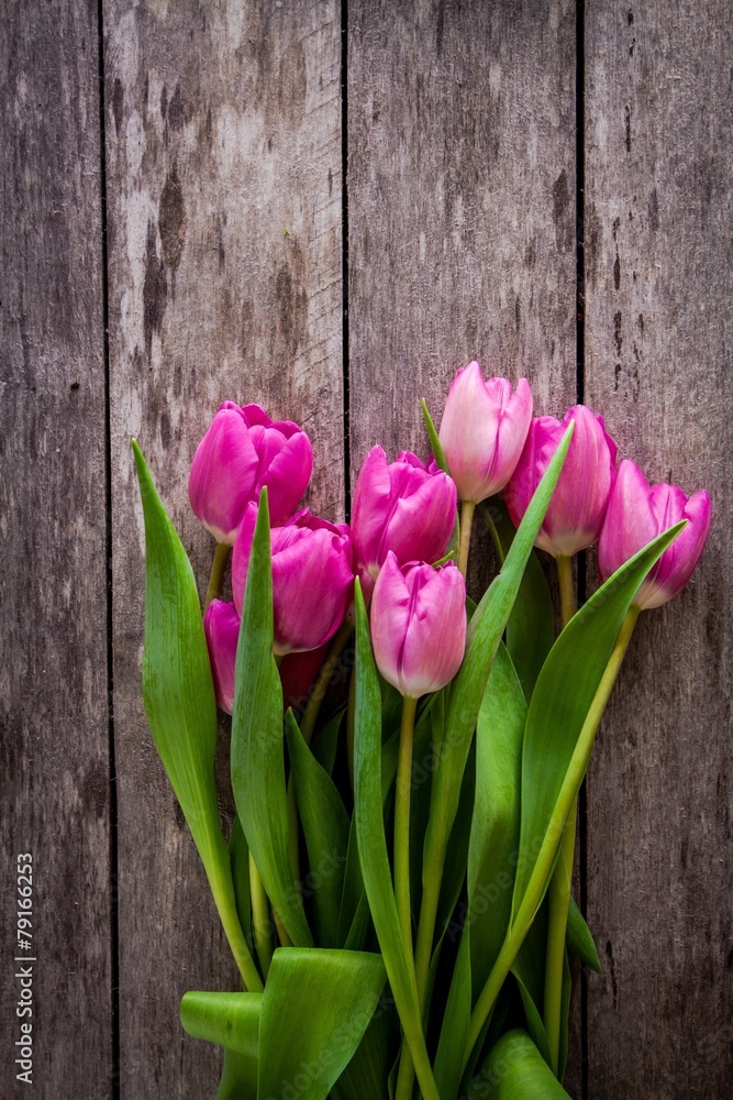bouquet of purple tulips on a wooden background bouquet of purple tulips on a wooden background