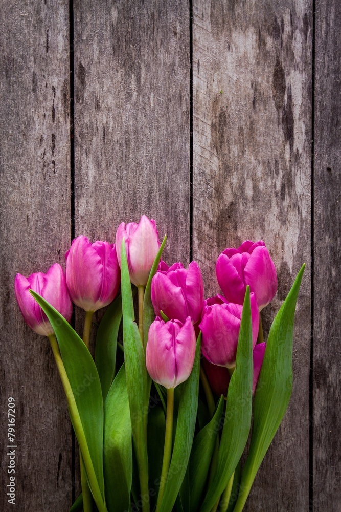 bouquet of pink tulips on a wooden background