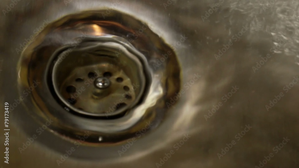 Clean water flowing down the drain Clean water flowing down the drain