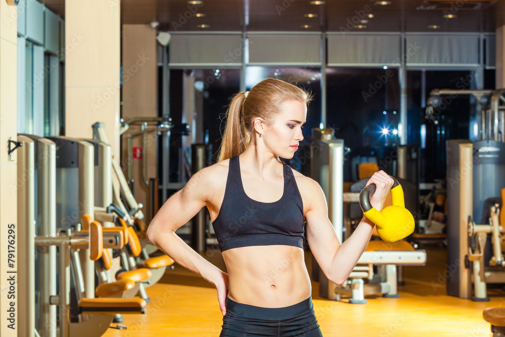 Fototapeta premium Fitness woman exercising crossfit holding kettlebell strength