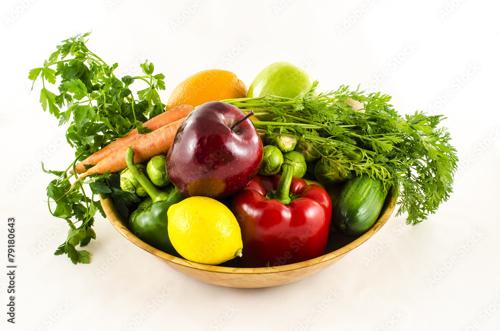 Composition of fresh fruits and vegetables in wooden bowl Composition of fresh fruits and vegetables in wooden bowl