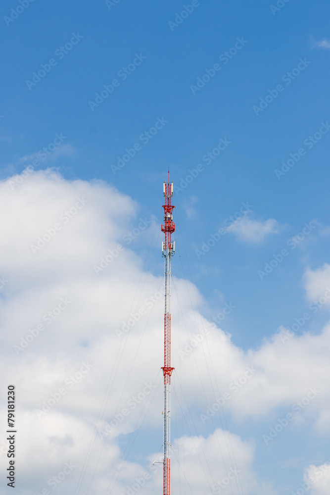 Outdoor tele communication red and white tower blue sky and clou Outdoor tele communication red and white tower blue sky and clou