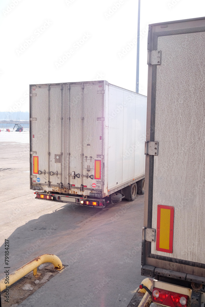 Trucks are loaded at the warehouse Trucks are loaded at the warehouse