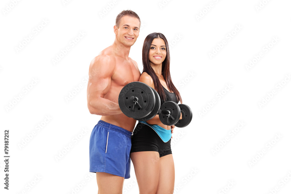 Couple of young athletes exercising with barbells Couple of young athletes exercising with barbells