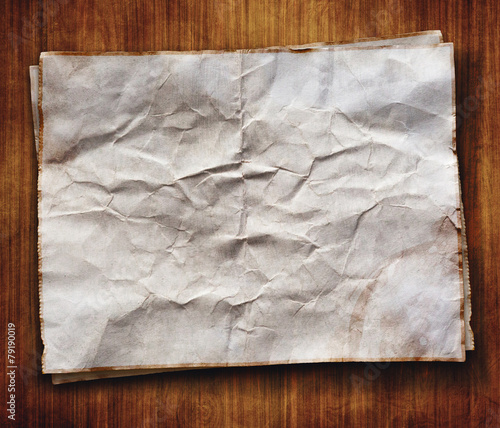 Vintage paper card on wooden texture