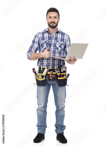 Confident handyman with laptop