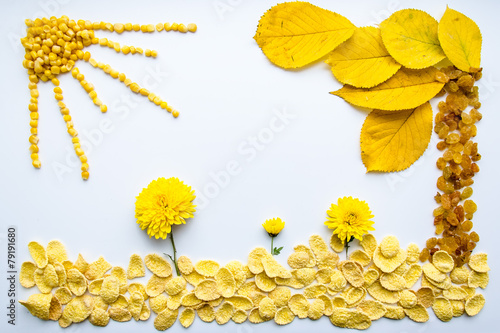 Картина из еды и листьев в желтом цвете на белом фоне photo