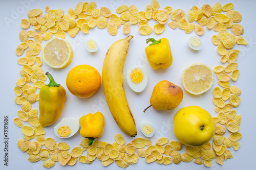 Картина из еды в желтом цвете на белом фоне photo