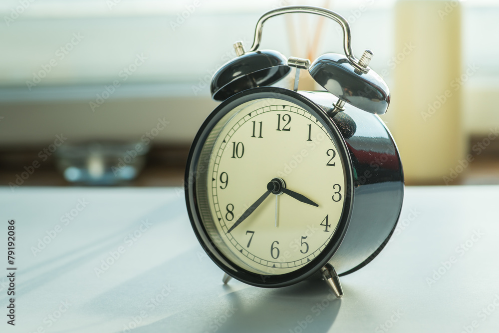 Alarm clock on the table near the window Alarm clock on the table near the window