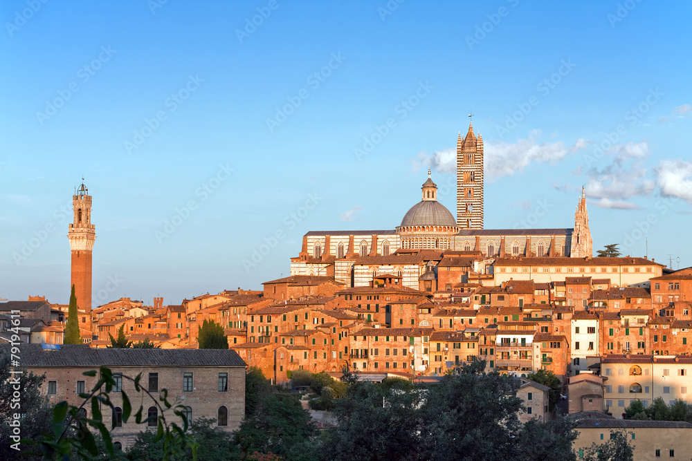 View of medieval old town of Siena, Italy at sunset