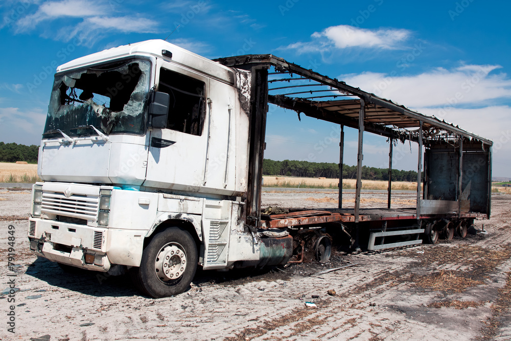 Burned-out truck in a field