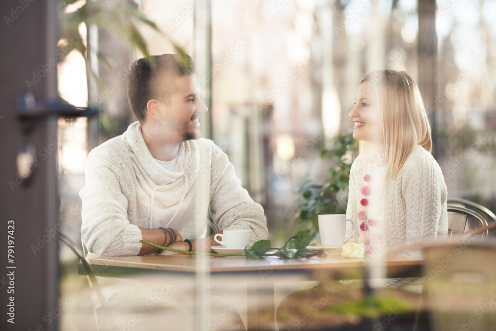 Cheerful young couple on a romantic date in a café. Cheerful young couple on a romantic date in a café.