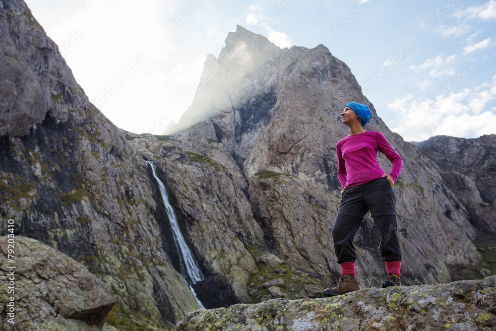 Woman with backpack is hiking in Caucasus mountains in Georga
