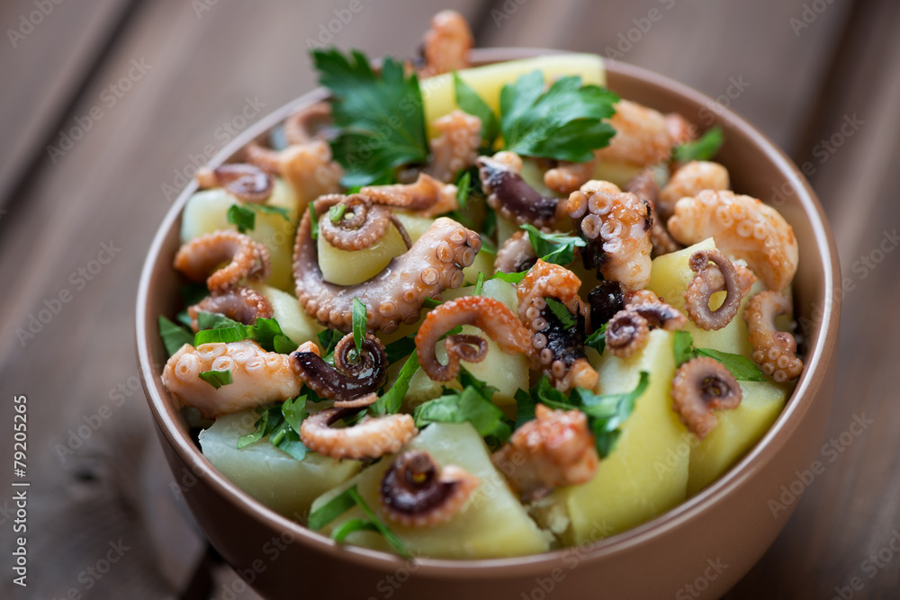 Octopus salad with potato and parsley, selective focus