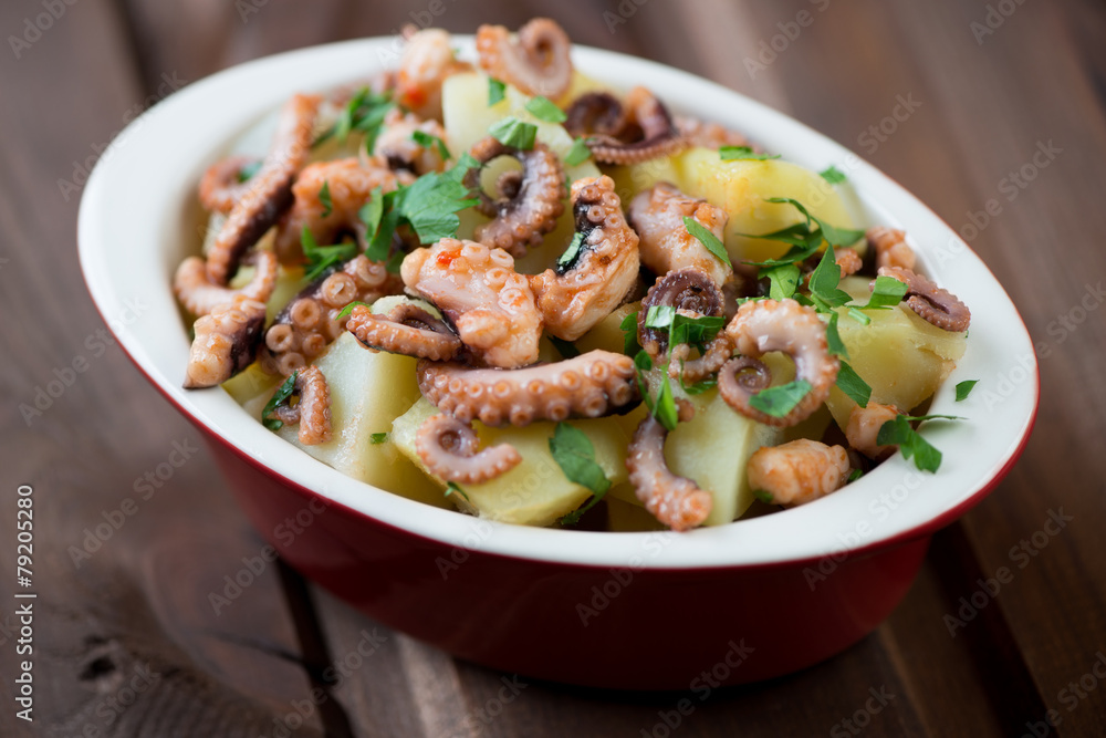 Octopus salad in a glass bowl, close-up, selective focus Octopus salad in a glass bowl, close-up, selective focus